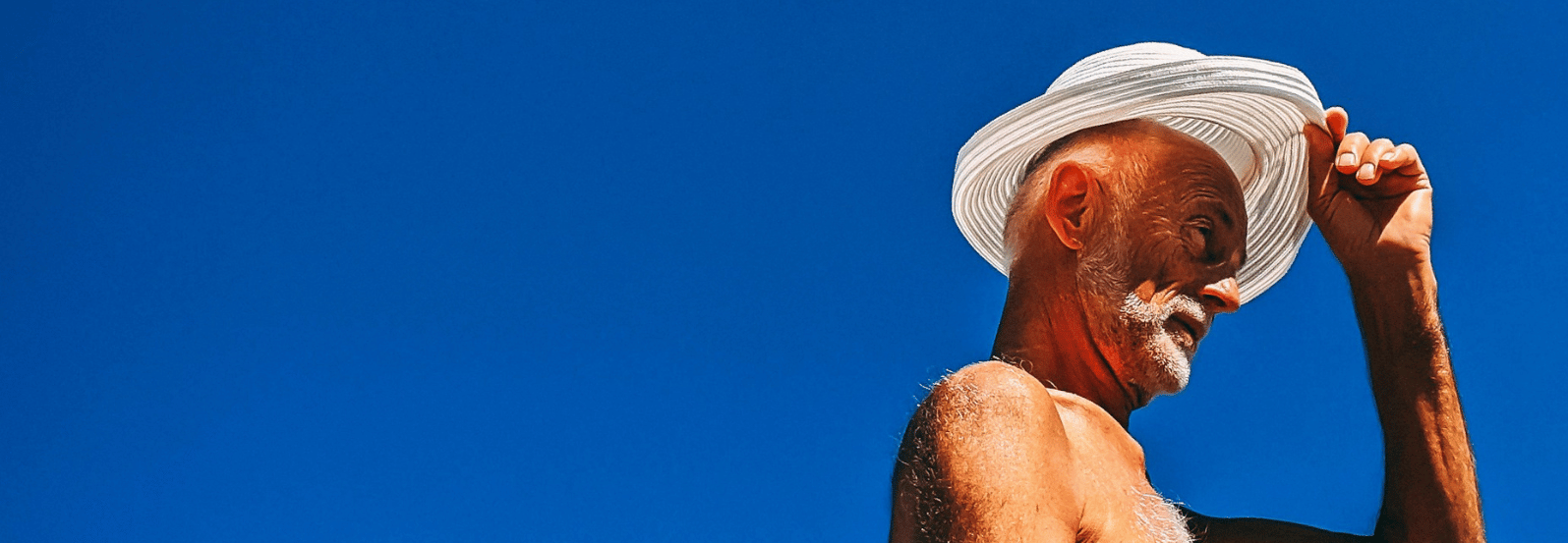 Caxton-NEWWEB-HERO-man-hat-blue-sky-1